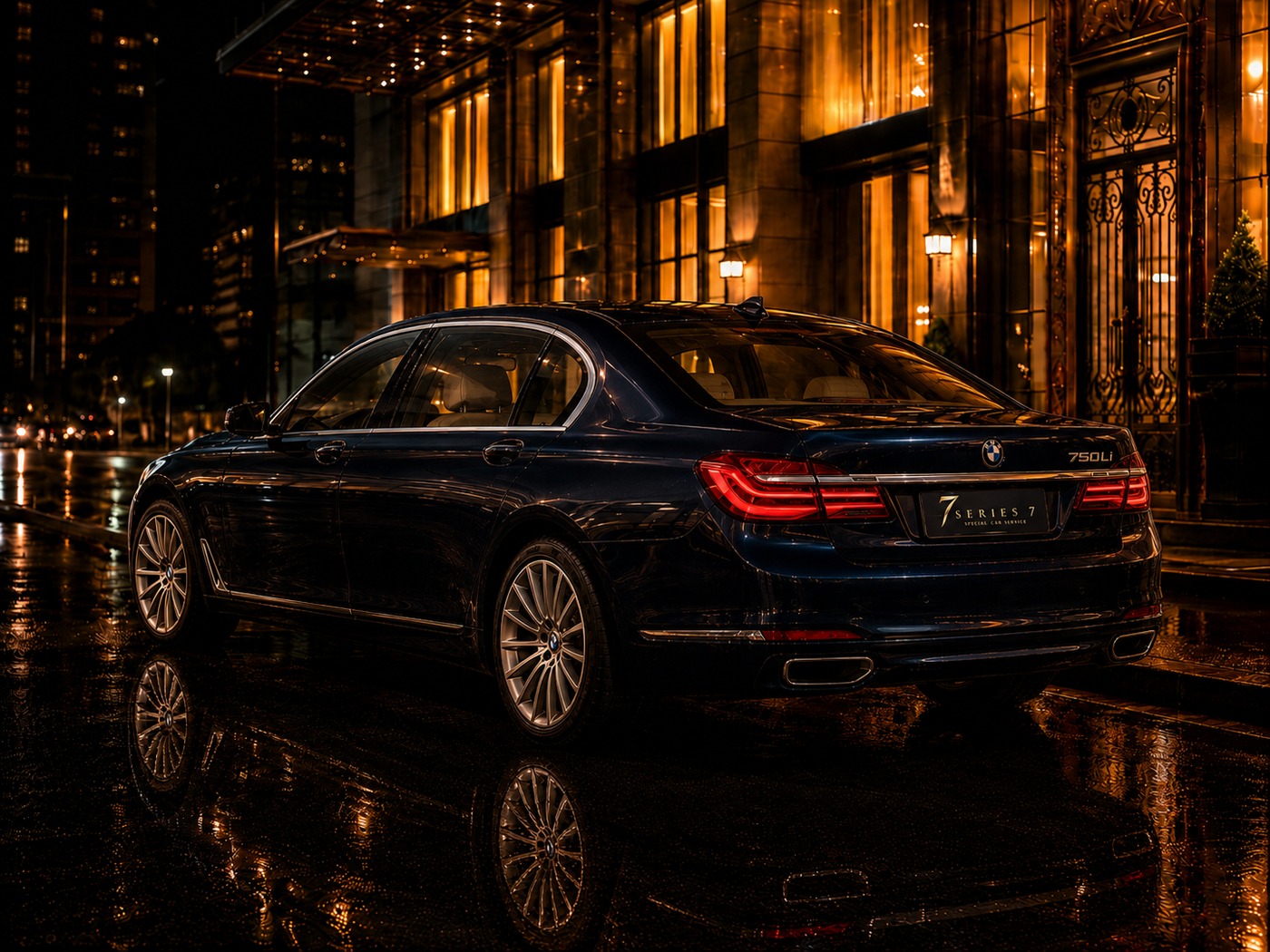 Rear three-quarter profile of a black BMW 7 Series sedan outside a gold-lit hotel
